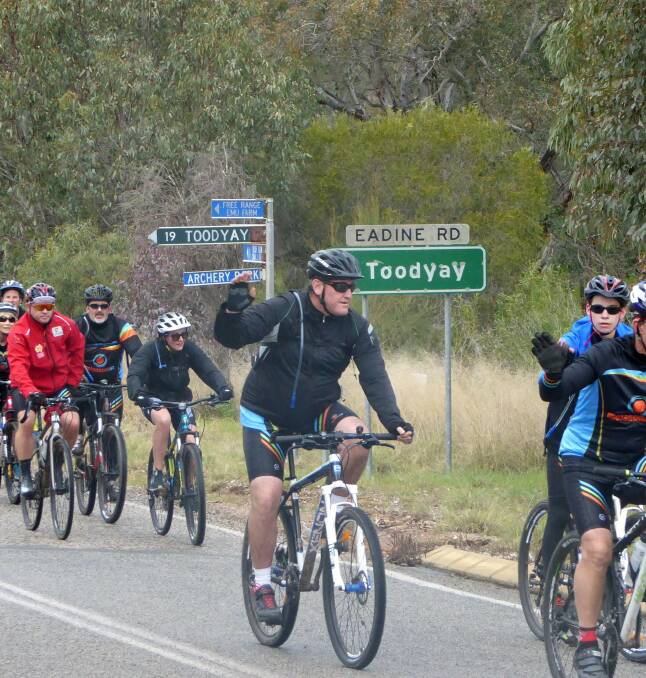 The group of riders making their way from Perth on Saturday. They stopped along the way to spread their message.