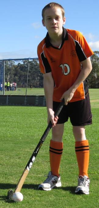 Ready: Jeremy Bignell all ready for action last Saturday in his uniform, holding onto a hockey stick. Jeremy plays for Titans Hockey Club and enjoys playing every week. 