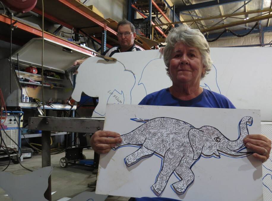 Design: Trevor Wibberley of Frames West and road safety ambassador Karen Ducat before the elephants shapes are cut out. A plasma is used to cut the shapes.