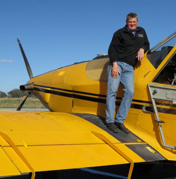 Spraying: Owner Scott Powell stands on his plane. Areas around Bruce Rock, Quaraiding and York have been hit, with rains making ground application difficult.