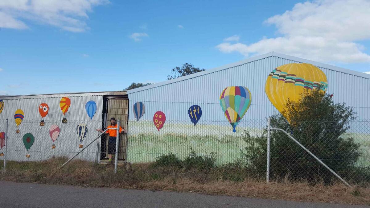 Trevor Peters, a 22-year-old volunteer, has been helping Earth Solutions – Avon Valley adorn balloons around town. 