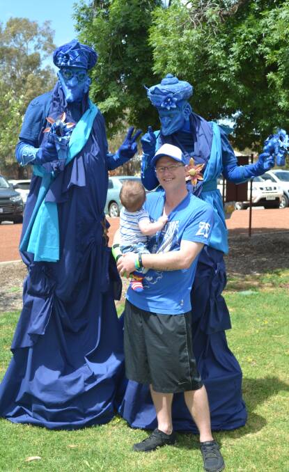 "I've never seen someone that tall!" Logan and Corey Angwin amazed by the blue performers at Turn Up In Blue Day for Mental Health Week on Friday. 