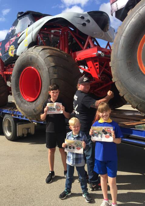 Monster Truck competition winners: Dylan Gorbig (12), Liam Smith (5) and Dakota Baker (9) with professional monster truck driver Troy Garcia. They stand next to monster truck Tom Cat, that will be in the show.