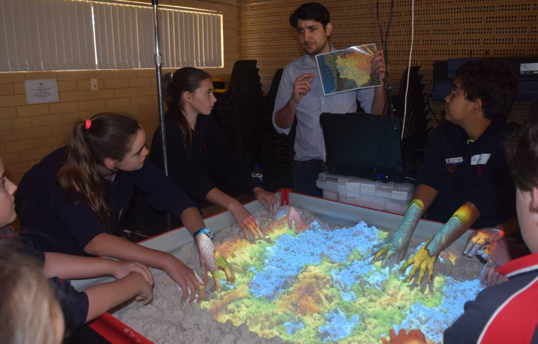 The Augmented Reality Sandbox helped students explore the characteristics of the Avon catchment. Pictured is Mr Chris David explaining topographic contour lines.