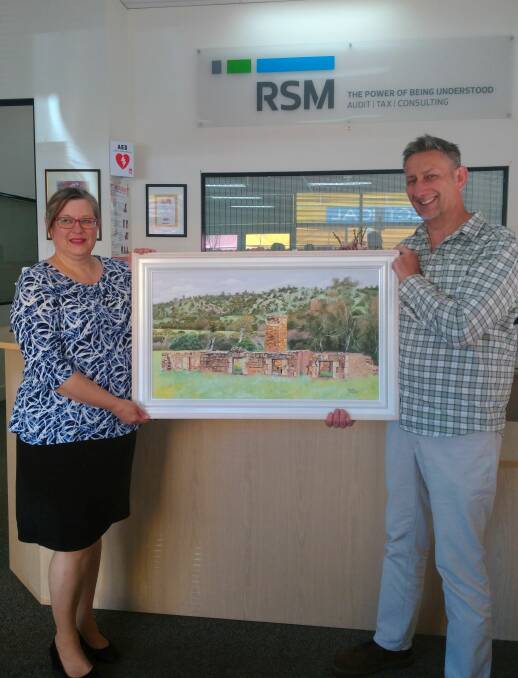 RSM representative Liz Greep and Cliff Simpson with the painting by Keith Hockley of Glenfield Homestead that was acquired by RSM Australia.