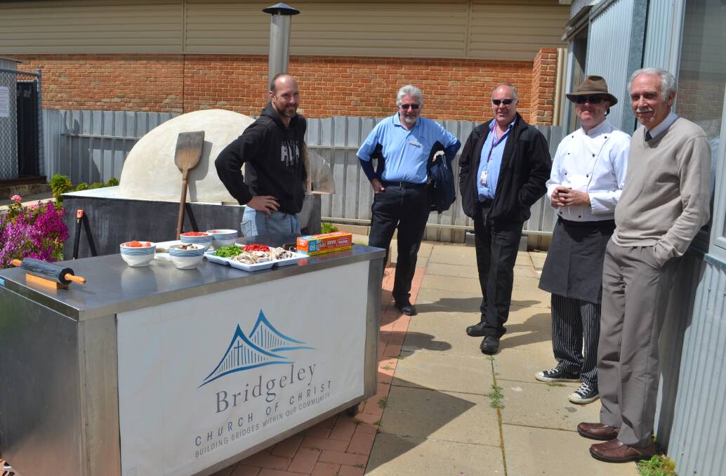 Kym Edwards, Les Holton, Brad Middleton, Michael and Colyn Smith having a chat around the new pizza oven.
