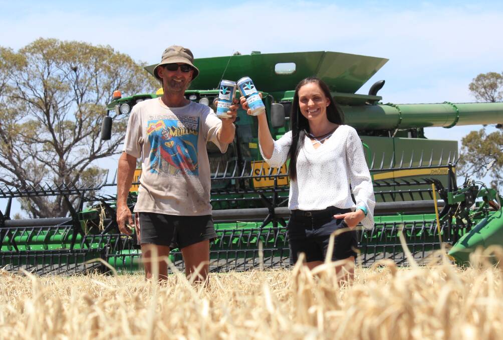 Meckering Sporting Club president Jeff Snooke and local farmer Rebekah Burges toast using local Bass barley to produce a commemorative beer next year.

