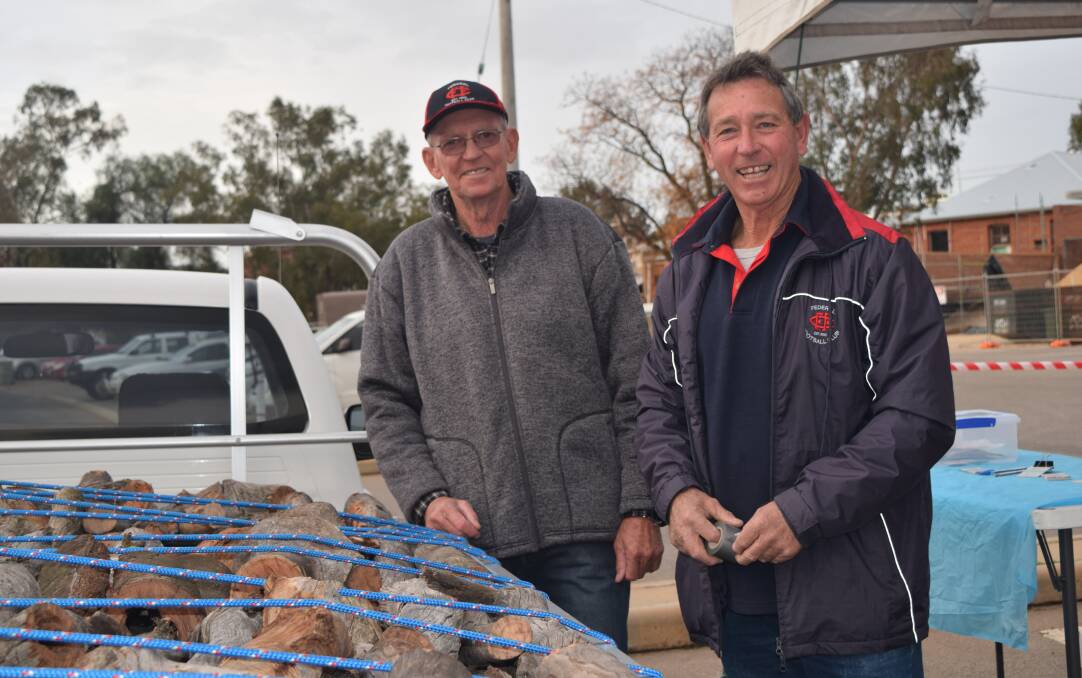 Volunteering for the team: Federals Football Club member Tony Hicks (Boomer) and president Phil Robinson sold raffle tickets for a load of wood at the Avon River Festival on Saturday night. 