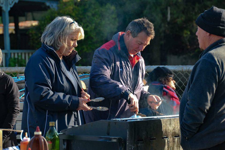 Early risers: Federals Football Club member Dianne Robinson and president Phil Robinson rugged up to cook breakfast at the Avon Descent. Photo: Tash Gillett.