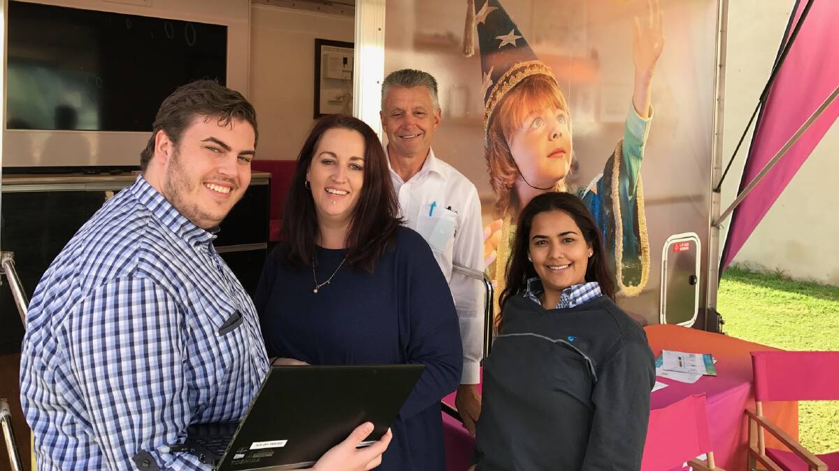 Luke Mal, Brian Cross and Ayesha Timori show Northam business owner Kym Burrow the benefits of being connected to the NBN.