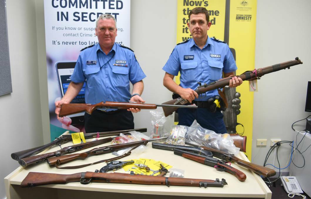 Amnesty: Inspector Peter Morrissey and acting senior sergeant Paul Williams hold up some of the guns handed in across the South West. Photo: Andrew Elstermann.
