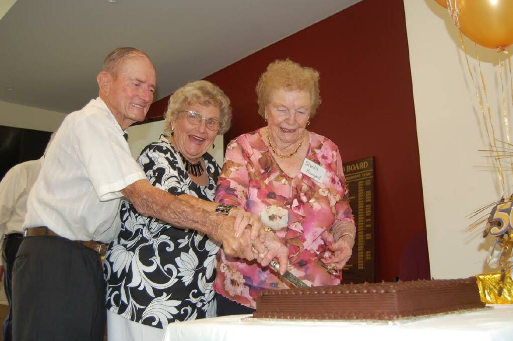 Trio: Life members John Metcalf, Thelma Hatwell and Sheila Munyard cut the cake.