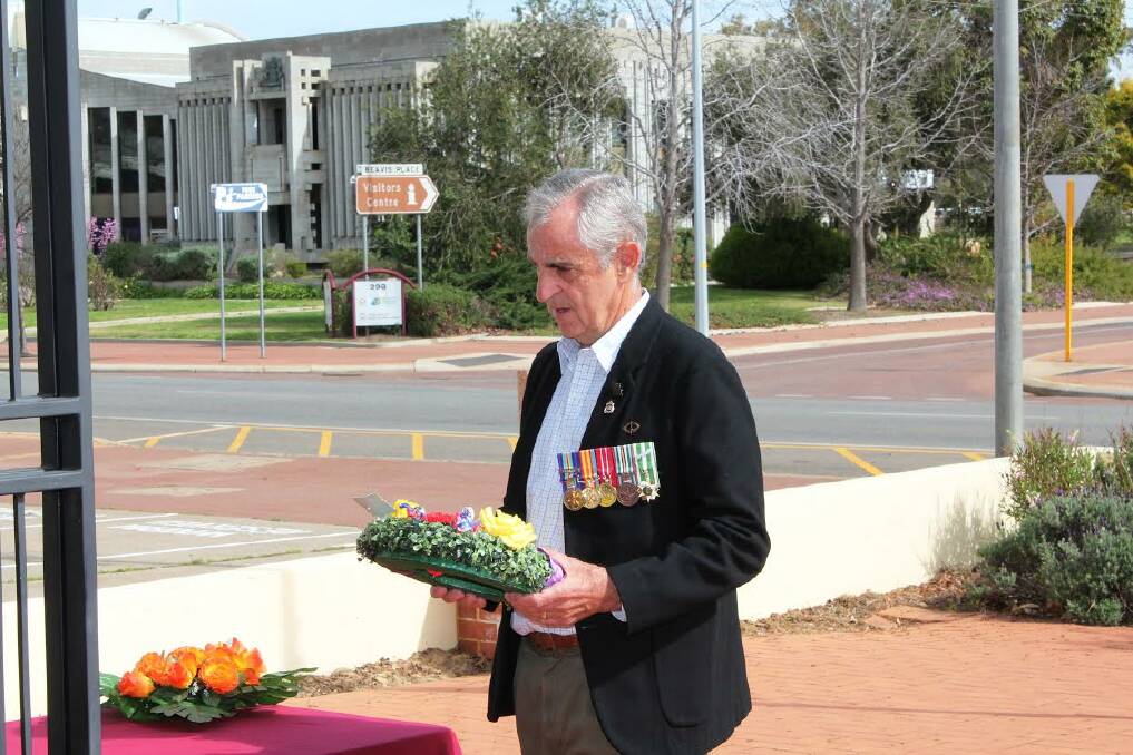 Respect: Northam Sub Branch treasurer Geoff Scarterfield prepares to place a wreath.