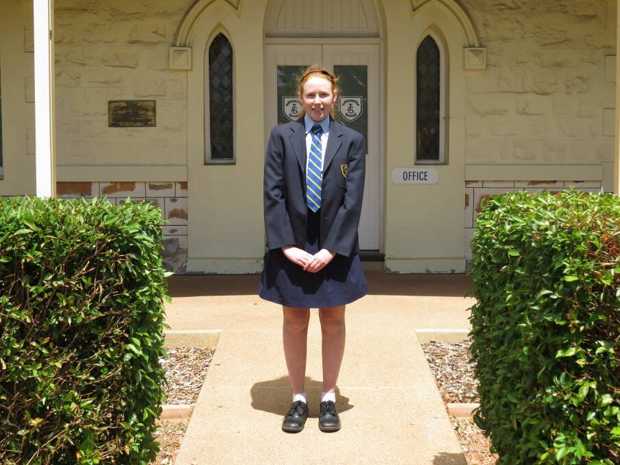 Anzac honour: Brie Runeckles in front of St Joseph's Secondary School.