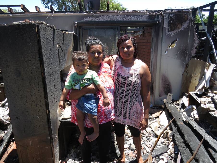 Fire: Rachael Bennell (right) with mother Rebecca and Filix outside the gutted Clarkson Street home.