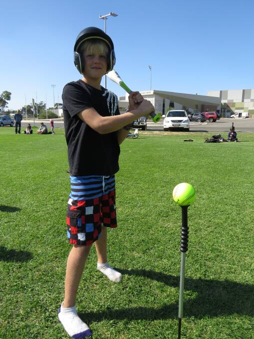 Batter up: Kayne Gorbig ready to tee off at last Thursday’s softball session.