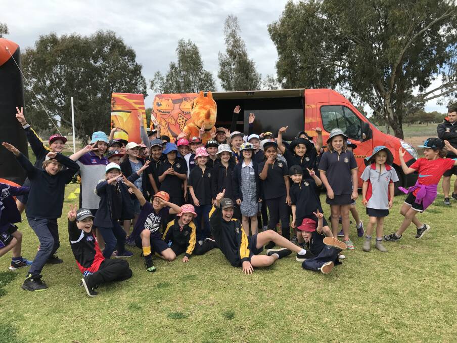 Scorching good time: Kids from York District High School enjoying a great time with the Scorchers bus and one of the mascots. Photo: supplied.