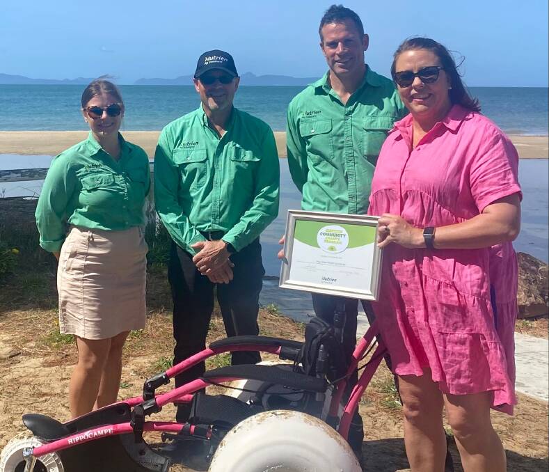 Nutrien Ag Solutions corporate affairs advisor Mady Muirhead, with Nutrien's Tom Adams and Josh Sattler and beach wheelchair equipment donated to Tasmanian aged and community health care provider, May Shaw, with May Shaw chief executive, Fiona Onslow-Angew. 