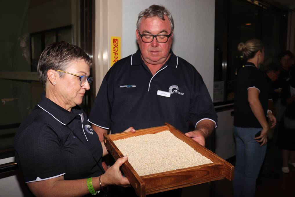 Judith Nolan, Salmon Gums and Chris Ross, Gairdner, inspect some of the WA malt barley used by Sanwa Shurui to brew their special shochu spirit.