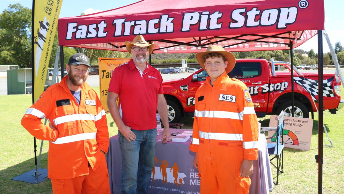 Dion (left) and Christian Fisher (right), SES Narrogin, stopped by to chat to Chris Gibbs, at The Regional Mens Health Initiative tent.