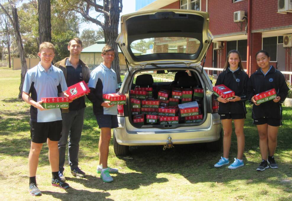 Fourty six boxes full of gifts: Year 9 students Andy Penny and Will Butcher, YouthCARE chaplain Wilson Cooper and Year 8 students Queen Ochaco and Adeline Chapman.