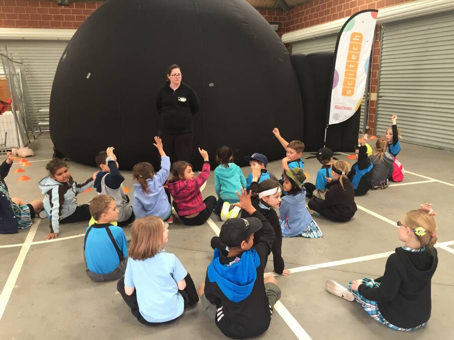 Avonvale year one students asking Scitech worker Jess Scholle questions about space, before going into the space dome. 