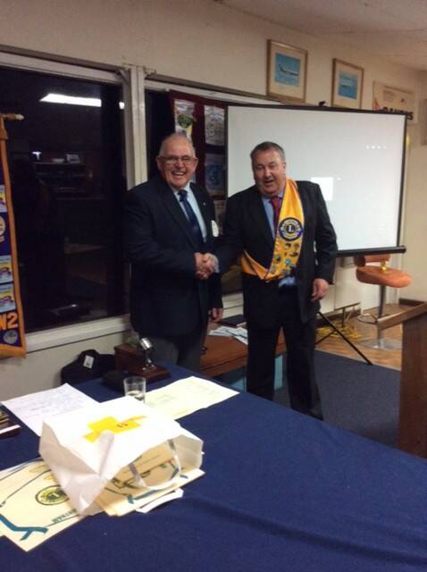Past president Harry Taylor passing the reigns and congratulating new Northam Lions president Wayne Morgan.