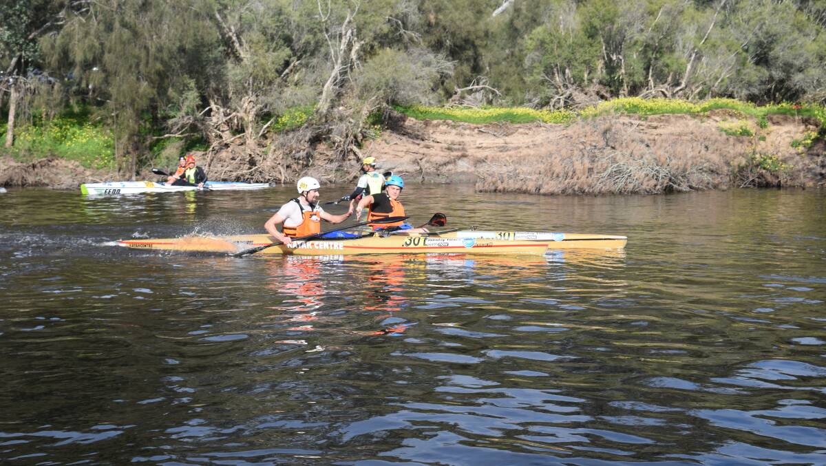 Powering on: The superstar kayak team high fiving at the Katrine Bridge swap over on Saturday, day one of the Avon Descent. 