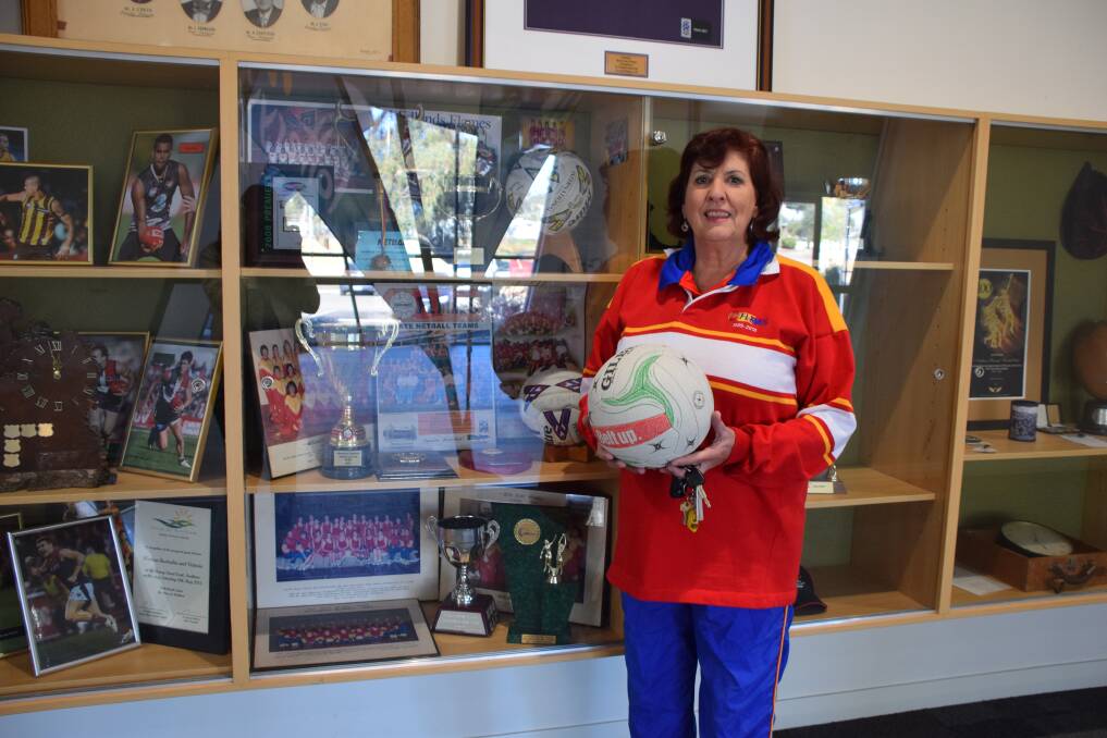 Adele Simmons from Wheatbelt Flames Netball Club with the club's awards at the Northam Recreation Centre.