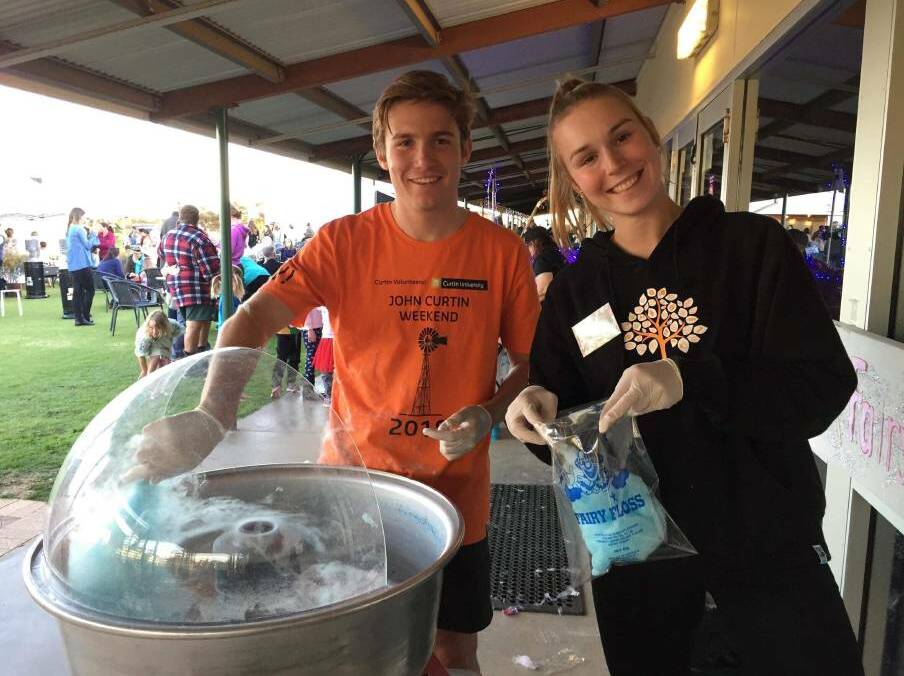 Curtin Volunteers Sam Moffat and Lauren Fleming helping at last year's Mukinbudin Art Show and Community Festival.