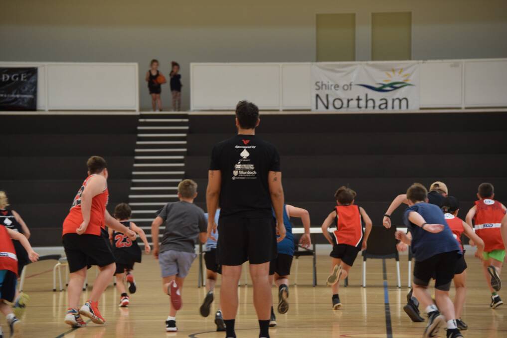 Retired Wildcats star Matty Knight guides Northam children in basketball drills during the two-day camps at Northam Recreation Centre.