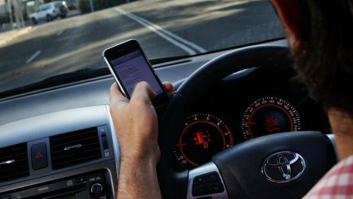 Tough new $1000 on the spot fines for drivers "touching" a mobile phone