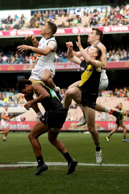 Hill flies for a mark in his debut game against Richmond. Photo: AAP/Mark Dadswell.
