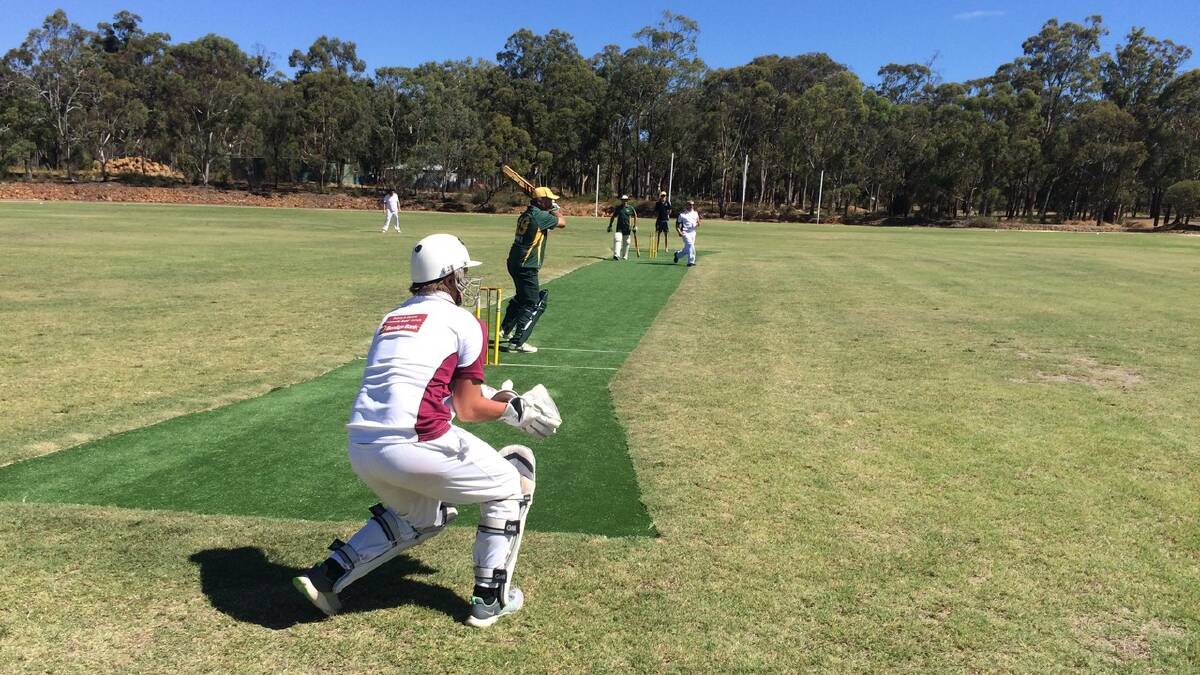 Ready: Bakers Hill player Paul Clune batting off Toodyay’s Steve McCormick. At the other end is Mick Carter and Toodyay’s wicket keeper. Photo: Henry Brayshaw. 