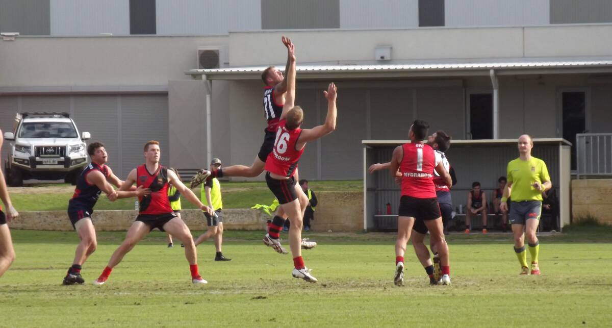 League: Federal's Jackson Lyons reaching high in the ruck for the clearance. Photo: Kathy Burges. 