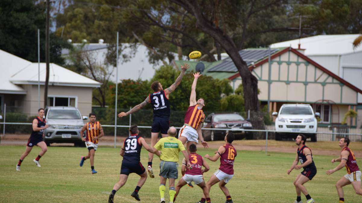 Derby rivalry: Federals' and Railways' ruckmen go up for the tap. Photo: Eliza Wynn. 