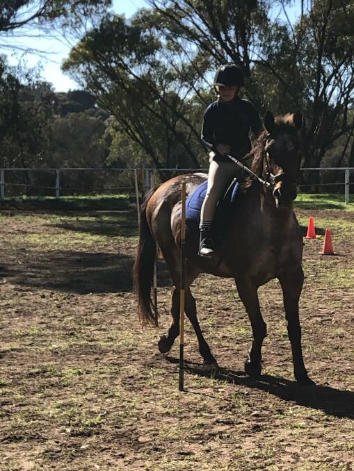 Fun and games: Hannah Smith practices the western bending race on Belle. Photo: Supplied.